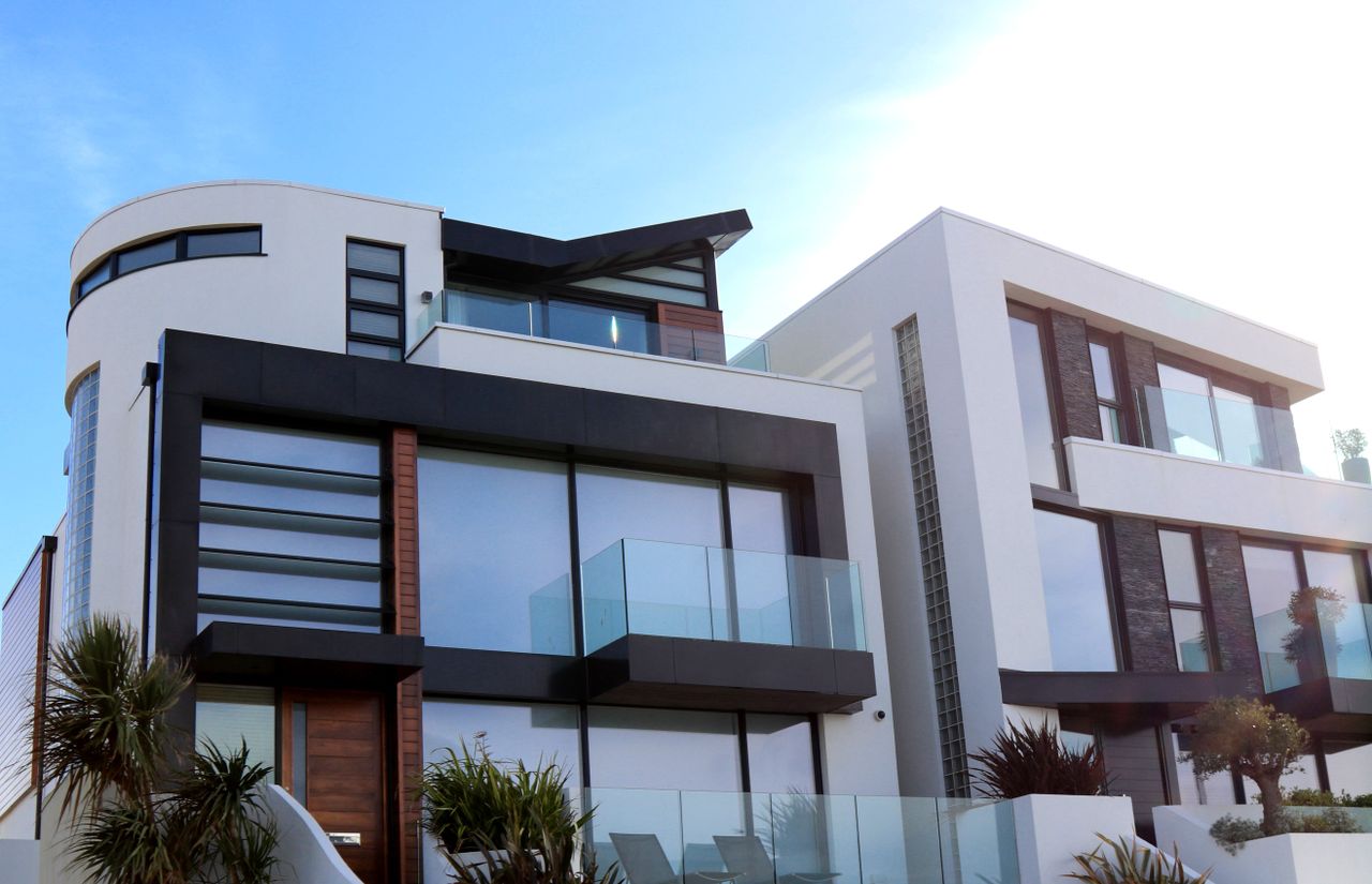 Crafting Captivating Headlines: Your awesome post title goes here Contemporary luxury home with glass balconies in Poole, UK, showcasing modern architectural design.